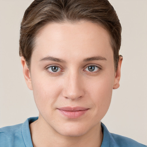 Joyful white young-adult female with short  brown hair and grey eyes