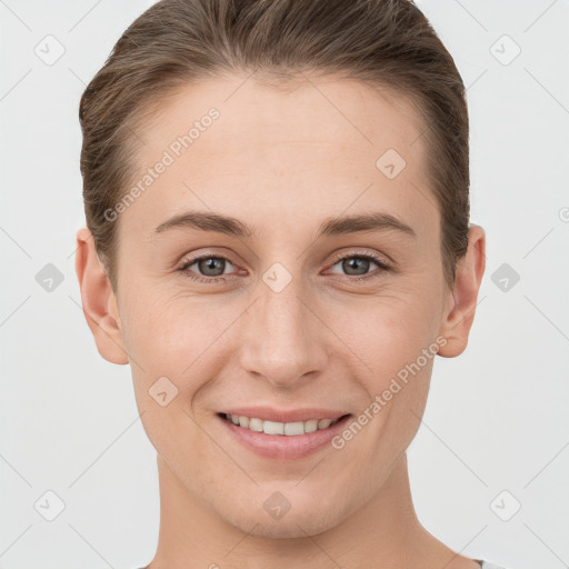 Joyful white young-adult female with short  brown hair and grey eyes