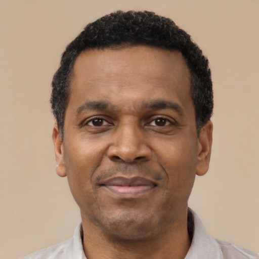 Joyful latino adult male with short  black hair and brown eyes