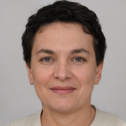 Joyful white adult female with short  brown hair and brown eyes