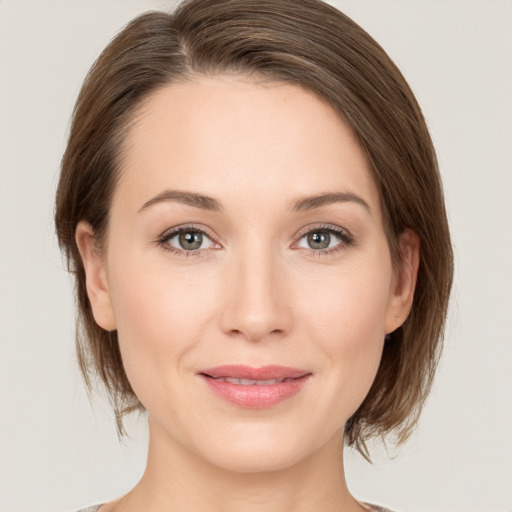 Joyful white young-adult female with medium  brown hair and grey eyes