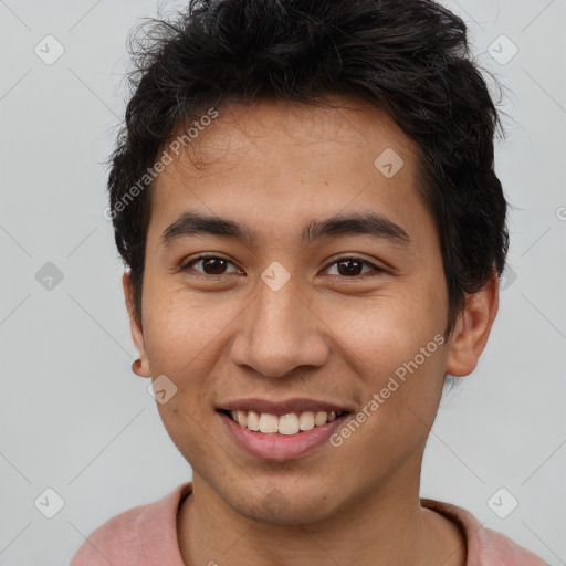 Joyful latino young-adult male with short  brown hair and brown eyes