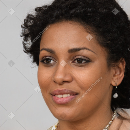 Joyful black young-adult female with long  brown hair and brown eyes