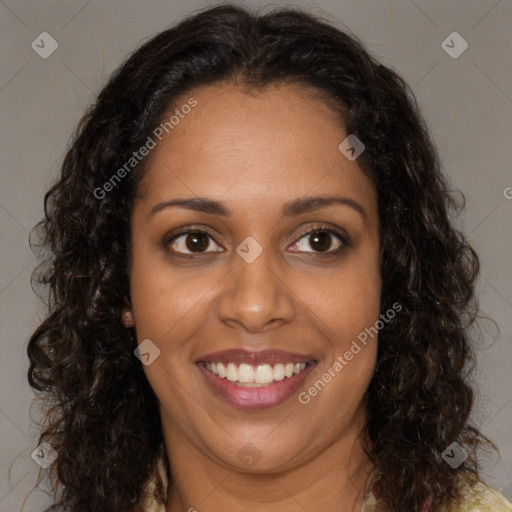 Joyful black young-adult female with long  brown hair and brown eyes