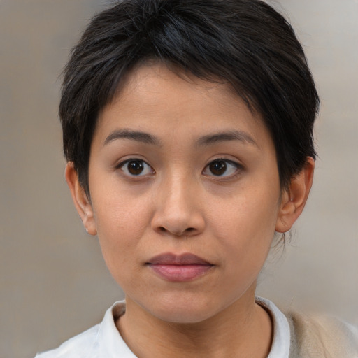 Joyful asian young-adult female with short  brown hair and brown eyes