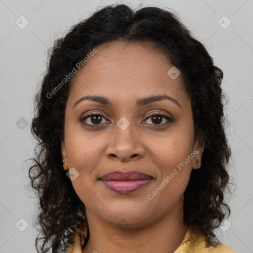 Joyful black young-adult female with long  brown hair and brown eyes