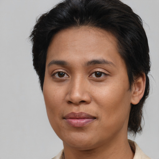 Joyful asian adult female with medium  brown hair and brown eyes