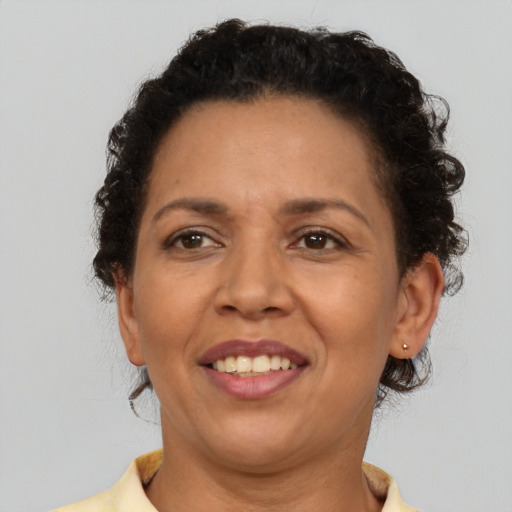 Joyful latino adult female with short  brown hair and brown eyes