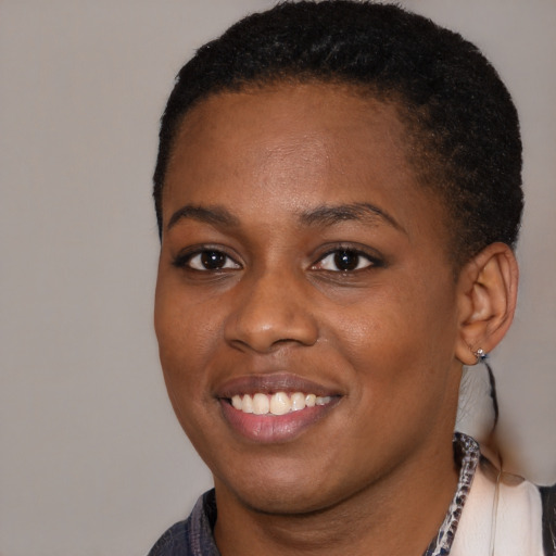 Joyful black young-adult female with short  brown hair and brown eyes