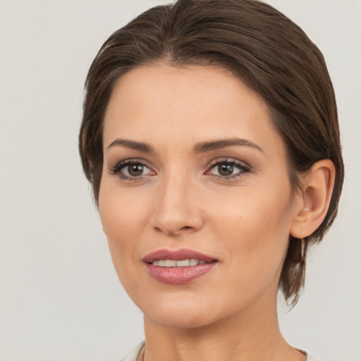 Joyful white young-adult female with medium  brown hair and brown eyes