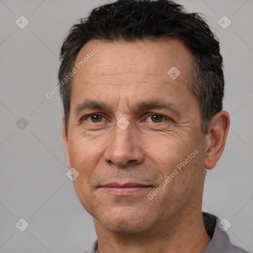 Joyful white adult male with short  black hair and brown eyes