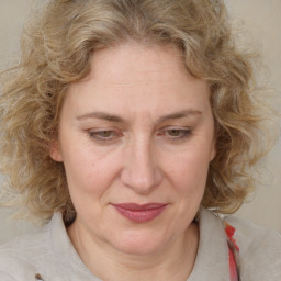 Joyful white adult female with medium  brown hair and blue eyes