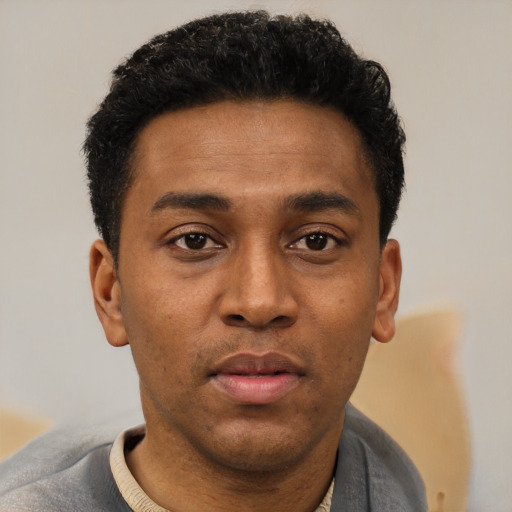 Joyful latino young-adult male with short  brown hair and brown eyes