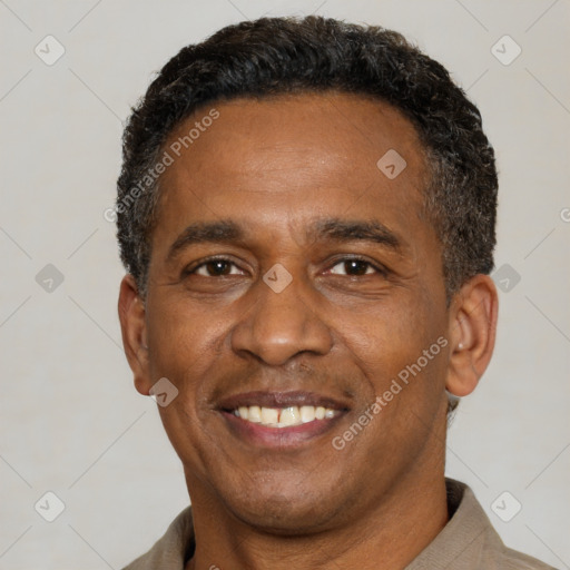 Joyful latino adult male with short  black hair and brown eyes