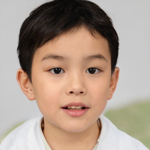 Joyful asian child male with short  brown hair and brown eyes