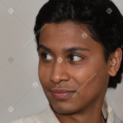 Joyful black young-adult male with short  black hair and brown eyes