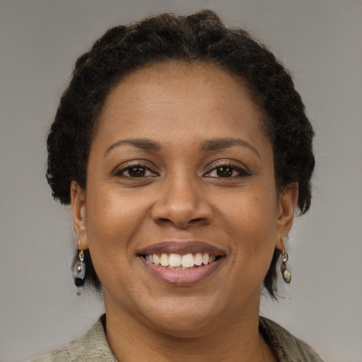 Joyful black adult female with short  brown hair and brown eyes