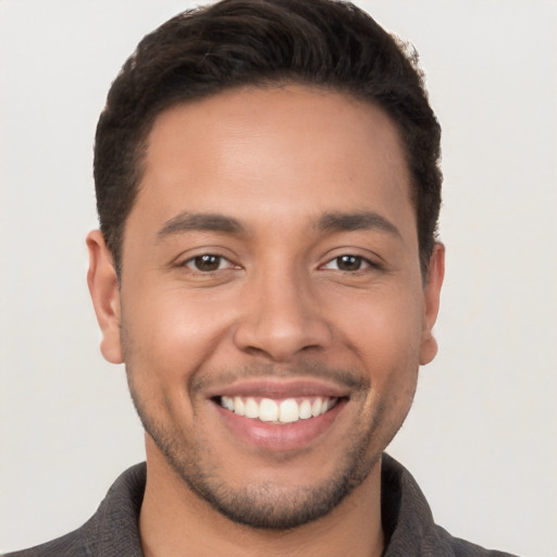 Joyful white young-adult male with short  brown hair and brown eyes