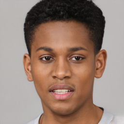 Joyful black young-adult male with short  brown hair and brown eyes