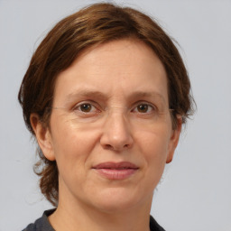 Joyful white adult female with medium  brown hair and grey eyes