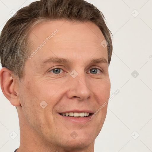 Joyful white adult male with short  brown hair and grey eyes