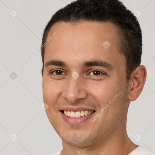 Joyful white young-adult male with short  brown hair and brown eyes