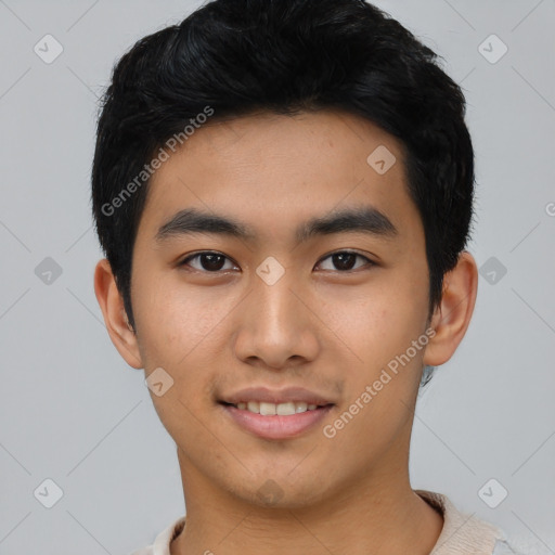 Joyful asian young-adult male with short  black hair and brown eyes