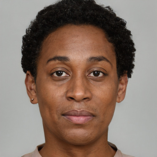 Joyful black adult female with short  brown hair and brown eyes