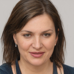 Joyful white adult female with medium  brown hair and brown eyes