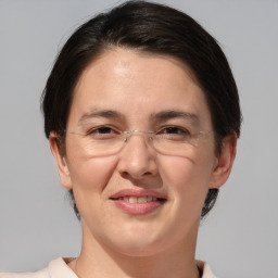 Joyful white adult female with medium  brown hair and brown eyes