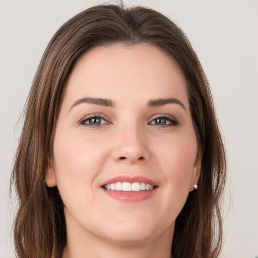 Joyful white young-adult female with long  brown hair and grey eyes