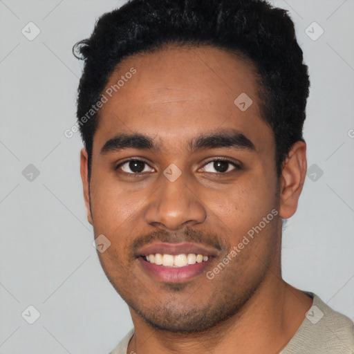 Joyful black young-adult male with short  black hair and brown eyes
