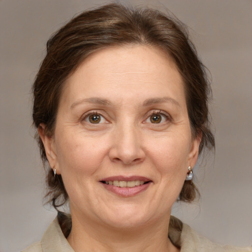 Joyful white adult female with medium  brown hair and brown eyes