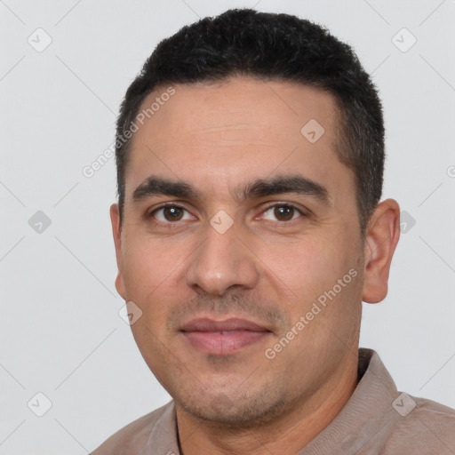 Joyful white young-adult male with short  black hair and brown eyes