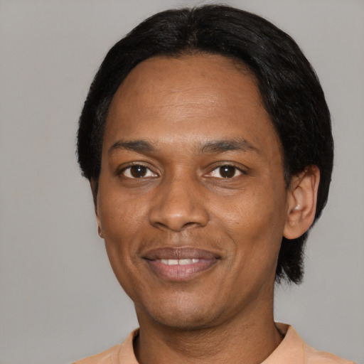 Joyful black adult male with short  black hair and brown eyes
