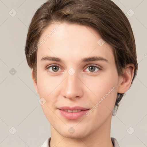 Joyful white young-adult female with short  brown hair and grey eyes