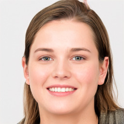 Joyful white young-adult female with long  brown hair and blue eyes