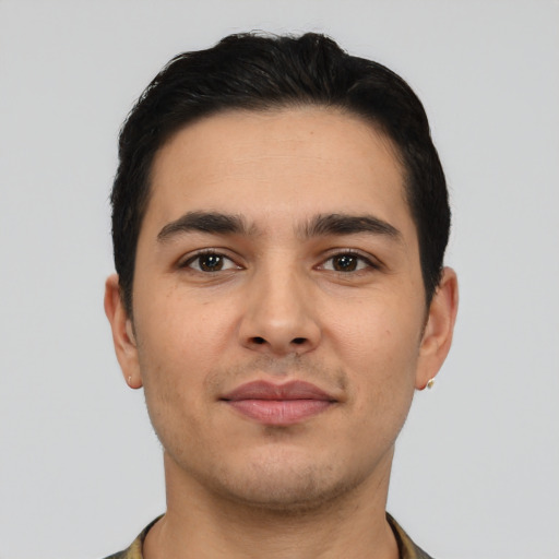 Joyful latino young-adult male with short  brown hair and brown eyes