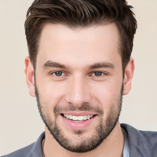 Joyful white young-adult male with short  brown hair and brown eyes