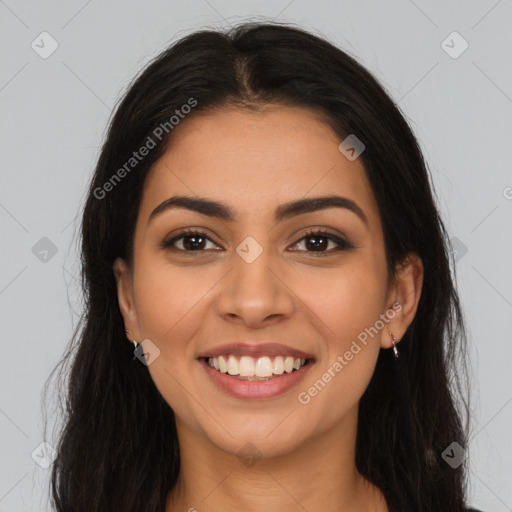 Joyful latino young-adult female with long  brown hair and brown eyes