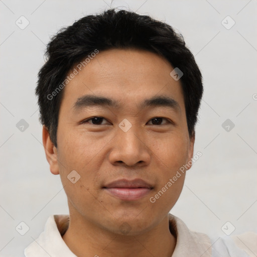 Joyful asian young-adult male with short  black hair and brown eyes