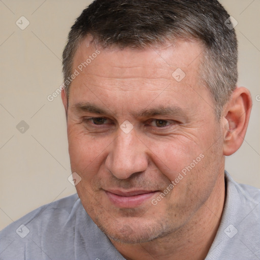 Joyful white adult male with short  brown hair and brown eyes