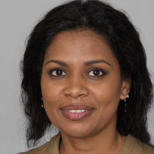 Joyful black young-adult female with medium  brown hair and brown eyes