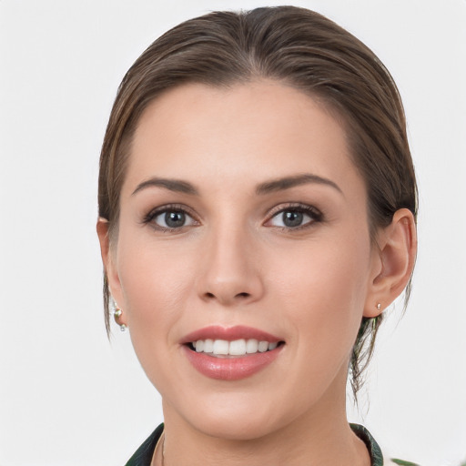 Joyful white young-adult female with medium  brown hair and grey eyes