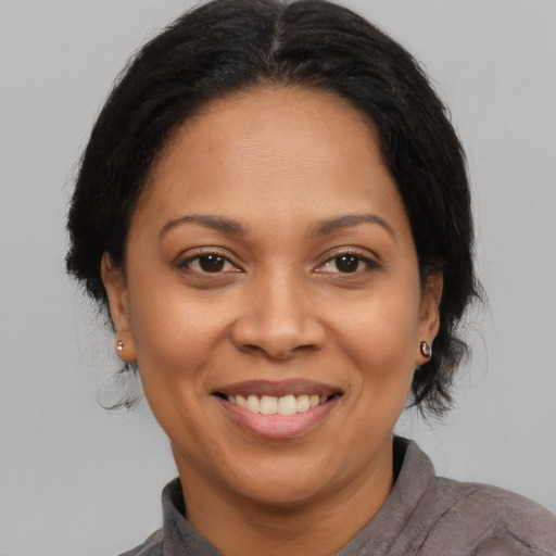 Joyful asian adult female with medium  brown hair and brown eyes
