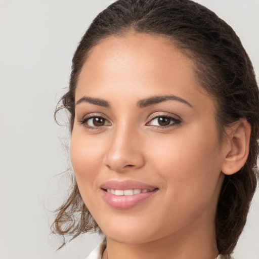 Joyful white young-adult female with long  brown hair and brown eyes