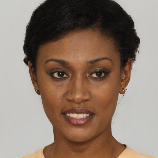 Joyful black young-adult female with short  black hair and brown eyes