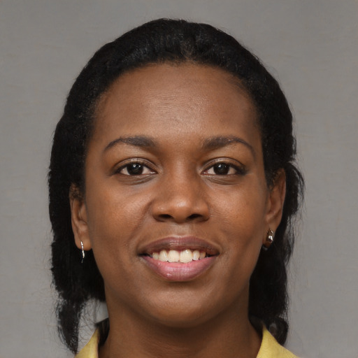 Joyful black young-adult female with medium  black hair and brown eyes