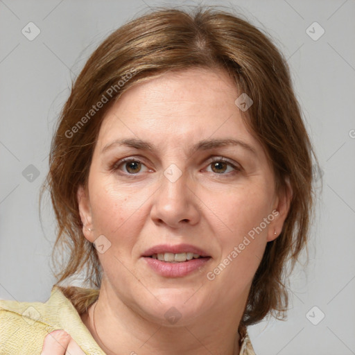 Joyful white adult female with medium  brown hair and grey eyes