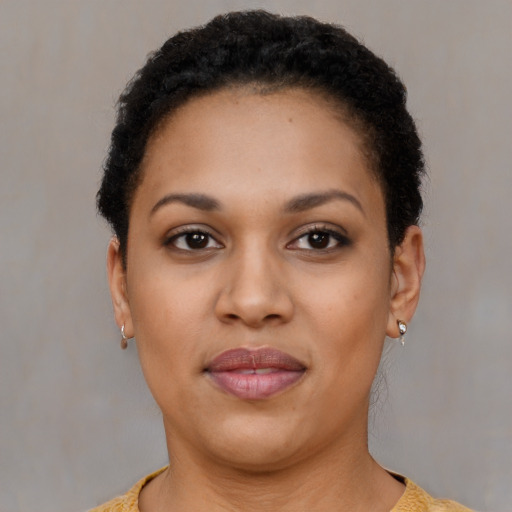 Joyful black young-adult female with short  brown hair and brown eyes